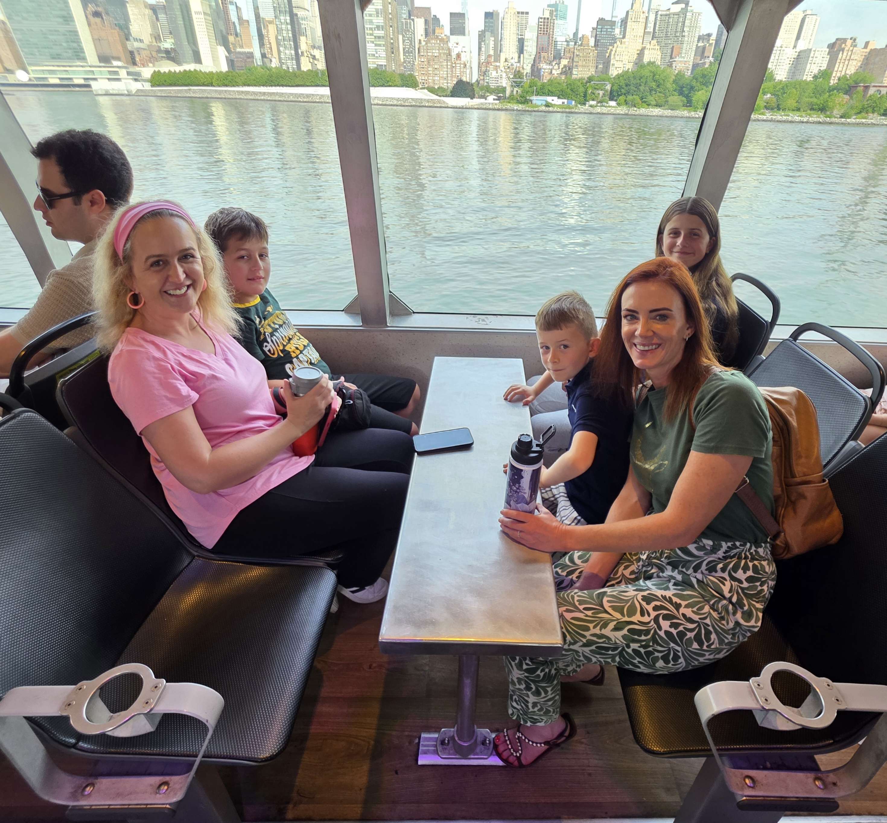 The family smiling together on the ferry.